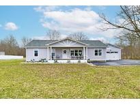 Charming single-story home with a covered porch and a well-maintained lawn at 18103 Eagletown Rd, Westfield, IN 46074