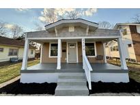 Charming bungalow featuring a covered front porch, freshly painted with new landscaping at 4504 Winthrop Ave, Indianapolis, IN 46205