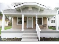 Charming home featuring a covered front porch with white columns and updated exterior at 4504 Winthrop Ave, Indianapolis, IN 46205