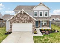 Charming two-story home with a brick facade and well-maintained landscaping, showcasing a welcoming curb appeal at 5520 N Woodside Ct, McCordsville, IN 46055