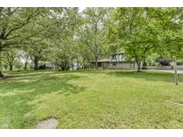 Expansive front yard with mature trees surrounding a two-story house at 569 King Dr, Indianapolis, IN 46260