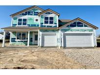 A newly constructed two-story home featuring a two-car garage and covered porch awaiting finishing touches at 5908 Agogo Way, Greenwood, IN 46143