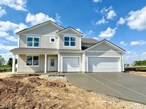 Charming two-story home featuring a two-car garage and a classic design with light neutral colors at 5908 Agogo Way, Greenwood, IN 46143