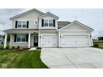 Charming two-story home featuring a spacious three-car garage and well-manicured front lawn at 5908 Agogo Way, Greenwood, IN 46143