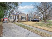 Charming single-story home with a quaint front porch and a well-maintained lawn and driveway at 6032 Norwaldo Ave, Indianapolis, IN 46220