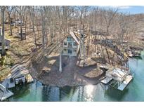 Striking lakefront home with a private dock and boat lift nestled among the trees, offering serene waterfront living at 6198 Grosbeak Dr, Nineveh, IN 46164