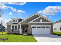 Beautiful exterior elevation with gray siding, stone accents, and a two-car garage on a well-manicured lawn at 7158 Rose Hill Ave, Brownsburg, IN 46112