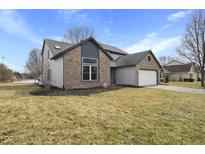 Charming two-story home featuring a brick and siding exterior with an attached two car garage at 7659 Camberwood Dr, Indianapolis, IN 46268