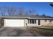 Ranch-style home with a large two-car garage and brick facade at 8137 S Delaware St, Indianapolis, IN 46227