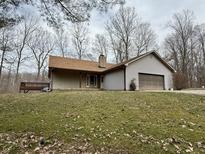Charming single-Gathering home with an attached two-car garage on a lush green lawn at 8490 Spearsville Rd, Morgantown, IN 46160