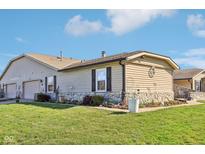 Charming single-story home with stone accents, manicured lawn, and attached two-car garage at 1001 Paradise Ct # D, Greenwood, IN 46143