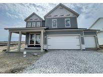 New construction home features a three car garage, gray siding, white trim, and covered porch at 16429 Mount Logan Rd, Noblesville, IN 46060