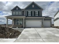 Two-story home showcasing a three car garage and a stylish gray exterior at 16429 Mount Logan Rd, Noblesville, IN 46060