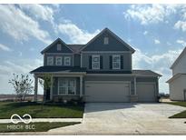 Charming two-story home with two-car garage, well-maintained lawn, and inviting curb appeal at 16429 Mount Logan Rd, Noblesville, IN 46060