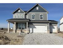 New two-story home featuring a three car garage and stylish gray siding against a brilliant blue sky at 16429 Mount Logan Rd, Noblesville, IN 46060