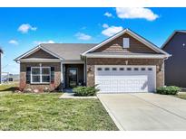 Charming brick home with well-maintained lawn, two-car garage, and inviting curb appeal at 257 Rambling Rd, Greenfield, IN 46140