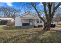 Charming single-story home featuring a welcoming front porch, mature trees, and a well-maintained lawn at 3039 Alice Ave, Indianapolis, IN 46237