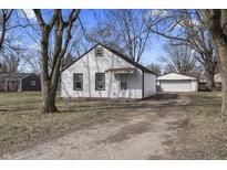 Charming home with white siding, nice yard, and detached garage, providing ample parking and curb appeal at 3104 Alice Ave, Indianapolis, IN 46237