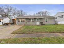 Charming single-story home with a well-maintained lawn, inviting porch, and neutral-colored siding at 610 Rose Ln, Mooresville, IN 46158