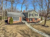 Charming two-story home featuring a brick and paneled exterior with a landscaped yard and winding walkway at 6400 Buttonwood Dr, Noblesville, IN 46062