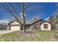 Charming brick home with a well-manicured lawn and inviting curb appeal at 7152 Sandalwood Dr, Avon, IN 46123