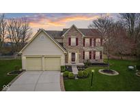 Charming two-story home with brick facade, manicured lawn, and two-car garage at 8937 Waterton Pl, Fishers, IN 46038