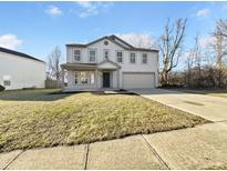 Charming two-story home with a well-manicured front lawn and attached two-car garage at 10291 Buckshire Ln, Indianapolis, IN 46234