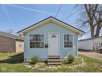 Charming light blue house with a well-maintained front yard and steps to the front door at 1039 S Ohio St, Martinsville, IN 46151