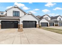 Charming townhouses with gray garages, stone accents, and white siding offer curb appeal at 10744 Eldorado Cir, Noblesville, IN 46060