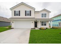 Charming two-story home features a two-car garage, black shutters, and a well-manicured lawn at 1265 Fleming Dr, Greenfield, IN 46140