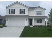 Charming two-story home featuring a well-manicured lawn, attached garage, and classic architectural details at 1265 Fleming Dr, Greenfield, IN 46140