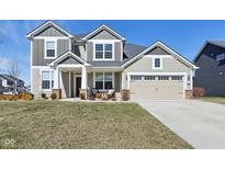 Charming two-story home features a two-car garage and cozy front porch at 13204 Caterwood Cir, Fishers, IN 46037
