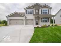 Charming two-story home featuring a spacious three-car garage and well-manicured front lawn at 1618 Trichel Dr, Greenwood, IN 46143