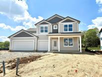 Charming two-story home featuring a three-car garage and covered porch, with gray and white trim at 1618 Trichel Dr, Greenwood, IN 46143