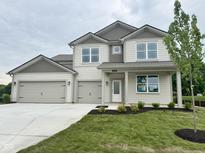 Charming two-story home featuring a three-car garage and a well-maintained front yard at 1618 Trichel Dr, Greenwood, IN 46143