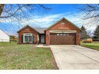 Charming brick home featuring a two-car garage and well-maintained lawn at 2117 Citation Dr, Indianapolis, IN 46234
