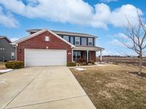 Two-story home featuring a blend of brick and vinyl siding, complemented by a well-manicured lawn and attached garage at 294 Rambling Rd, Greenfield, IN 46140