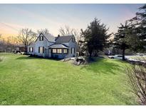 Charming home boasts a well-maintained lawn and a quaint enclosed porch at 3120 Central Ave, Anderson, IN 46016