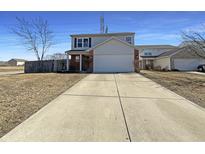 Charming two-story home with a two-car garage and a long driveway and manicured lawn at 3951 Narrowleaf Ct, Indianapolis, IN 46235