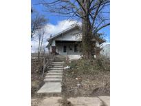 Exterior of a white house with a long concrete staircase leading up to the front door at 408 E Monroe St, Alexandria, IN 46001