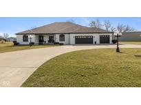 Stunning ranch-style home with a well-manicured lawn and an attached three car garage at 5529 W Mccord Rd, McCordsville, IN 46055