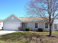 Charming single-story home with light siding, attached garage, and well-maintained front lawn on a sunny day at 6416 Raldon Rd, Anderson, IN 46013