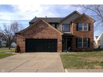 Charming two-story home with brick and vinyl siding, an attached two-car garage, and well-maintained landscaping at 6812 Cadwell Cir, Indianapolis, IN 46237