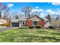 Charming single-Gathering home with a well-maintained lawn, attached garage, and brick accents at 9535 Broadway St, Indianapolis, IN 46240