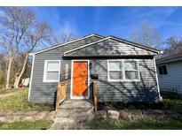Charming single-story home with gray siding and a vibrant orange front door at 1246 Mcdougal St, Indianapolis, IN 46203