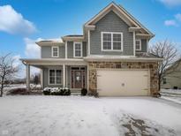 Charming two-story home featuring stone accents, attached two-car garage, and well-maintained landscaping at 13820 N Honey Creek Dr, Camby, IN 46113