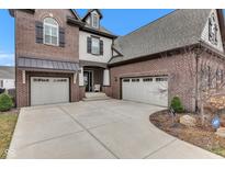 Spacious driveway leading to a two-car garage, highlighting the home's brick and siding exterior at 1521 Avondale Dr, Westfield, IN 46074