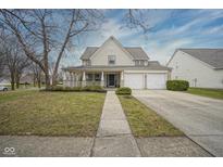Charming two-story home featuring an inviting front porch and a two-car garage on a well-maintained lot at 15520 Marietta Cir, Westfield, IN 46074