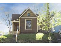 Charming brown house with a gabled roof, light trim, and a welcoming front porch at 249 N Hamilton Ave, Indianapolis, IN 46201