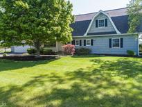 Charming home with gray siding, mature trees, and a well-manicured lawn at 3548 W 500 North Rd, McCordsville, IN 46055